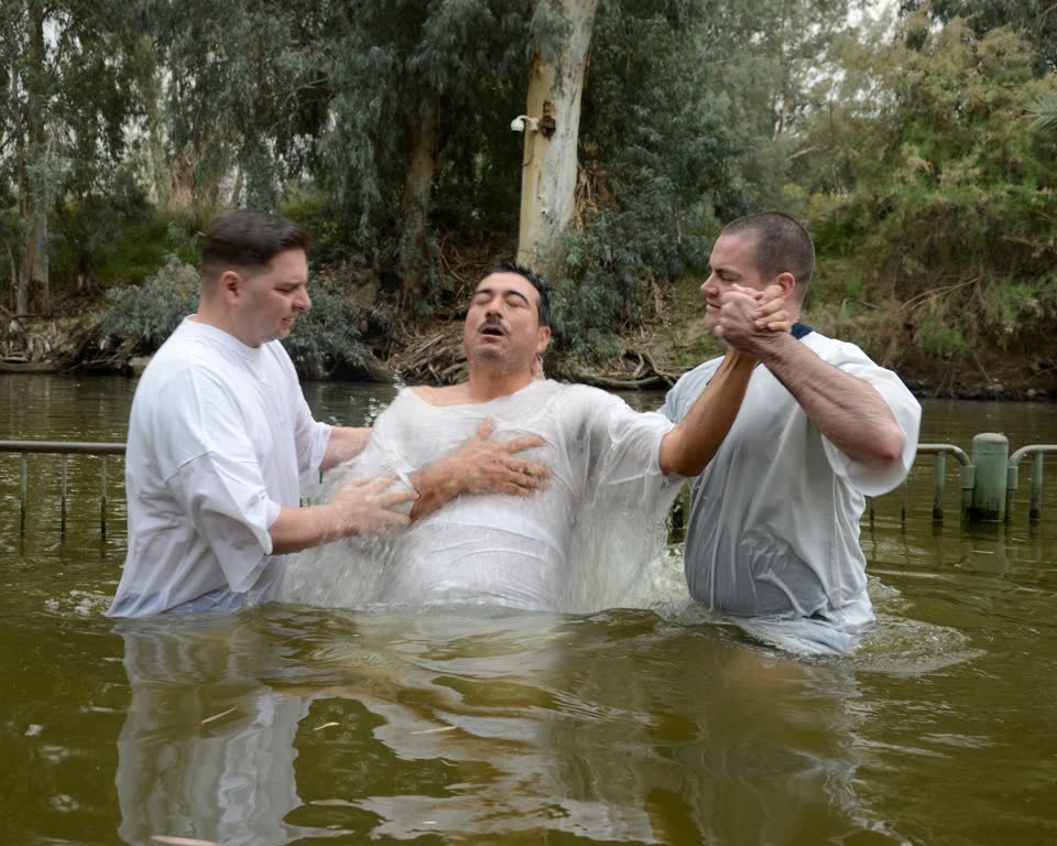A believer is baptized by immersion in the Jordan River in 2014. (File photo)