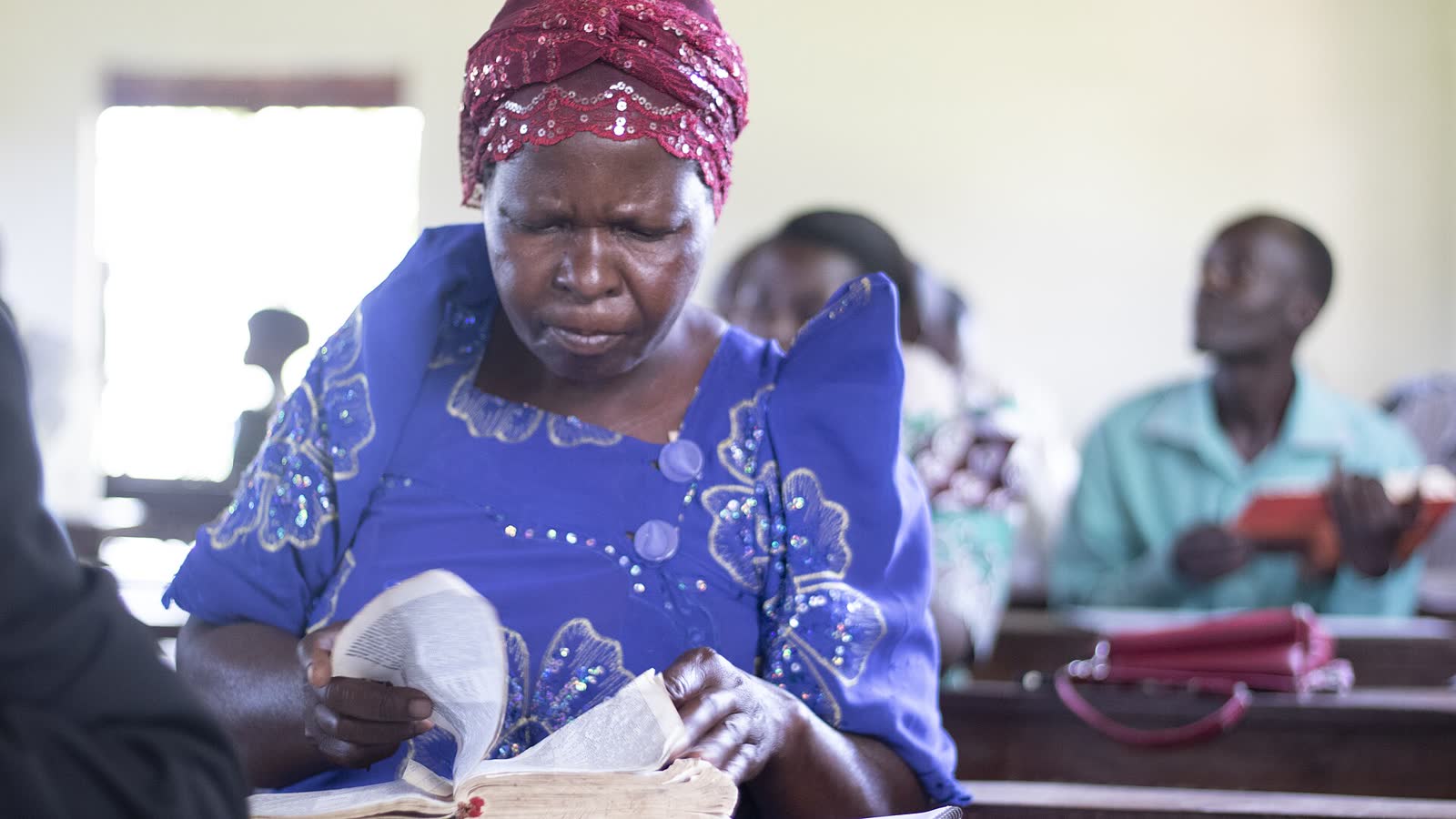 A woman reads her Bible during a church service. (File photo)
