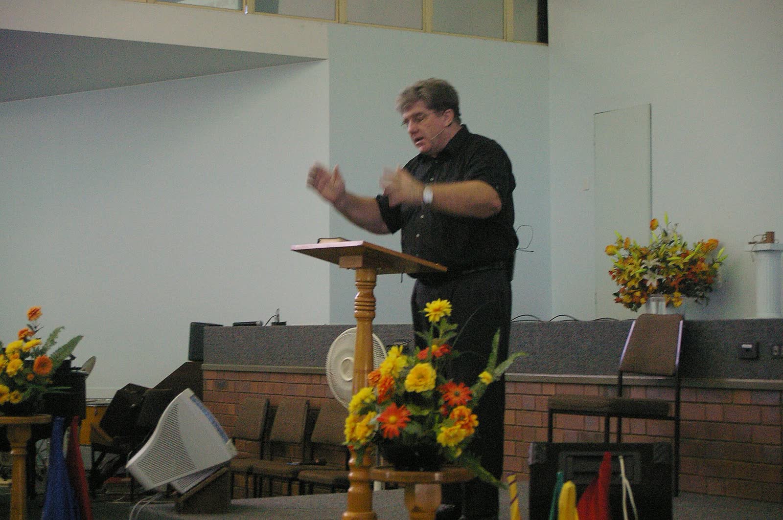 A pastor preaches at an outreach service; not one of the pastors in this story. (File photo)
