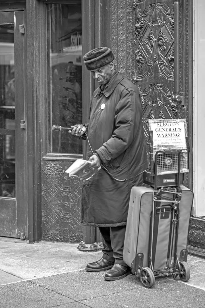 A street preacher with a microphone and portable speaker in Chicago. Amplification is at the center of the Colchester dispute. (File photo)