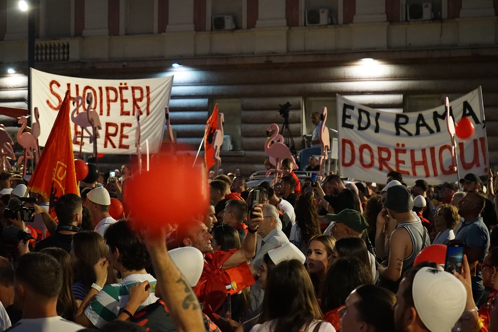 Protesters carry flamingo signs at a June 21, 2026, demonstration in Tirana; the protests began over a planned tourist complex at a flamingo reserve. (File photo)